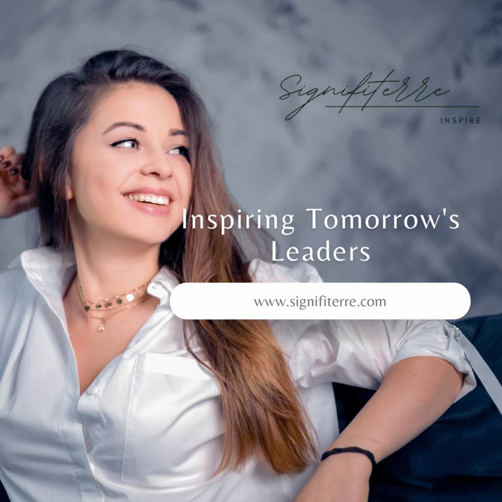 Confident young woman with long brown hair smiling upward in aspiration, wearing a white blouse and layered necklaces, against a soft cloudy background. Overlaid text reads "Signifiterre INSPIRE" and "Inspiring Tomorrow's Leaders" with the website www.signifiterre.com – representing the spirit of visionary leadership and positive impact.